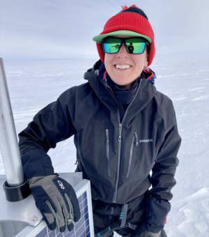 Laura with a solar panel on the Greenland Ice Sheet