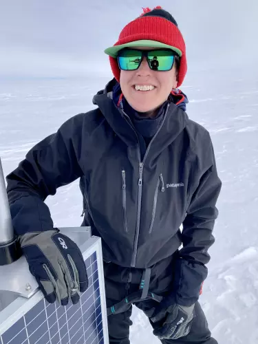Laura with a solar panel on the Greenland Ice Sheet